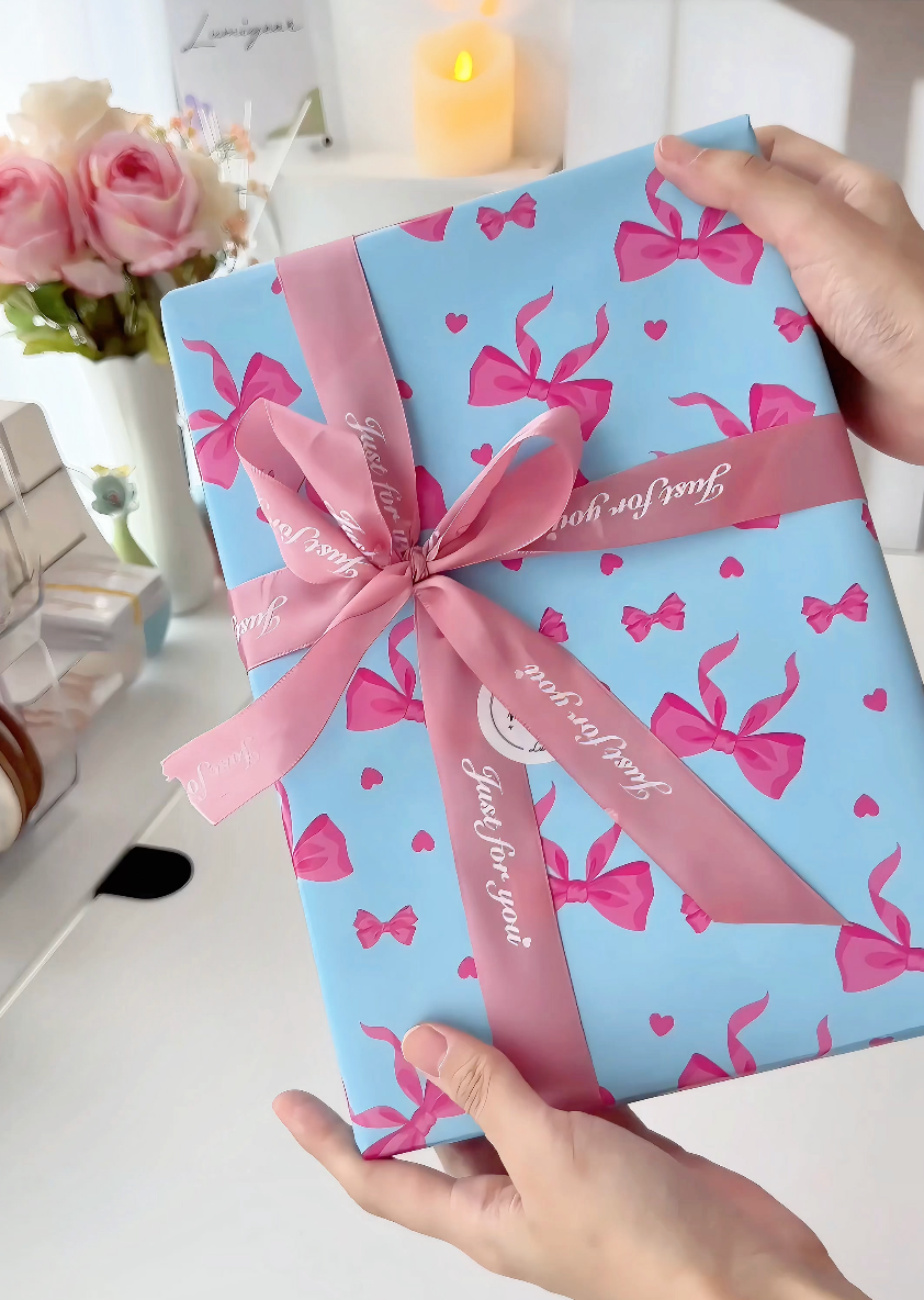 A stationery gift wrapped with a pink bow